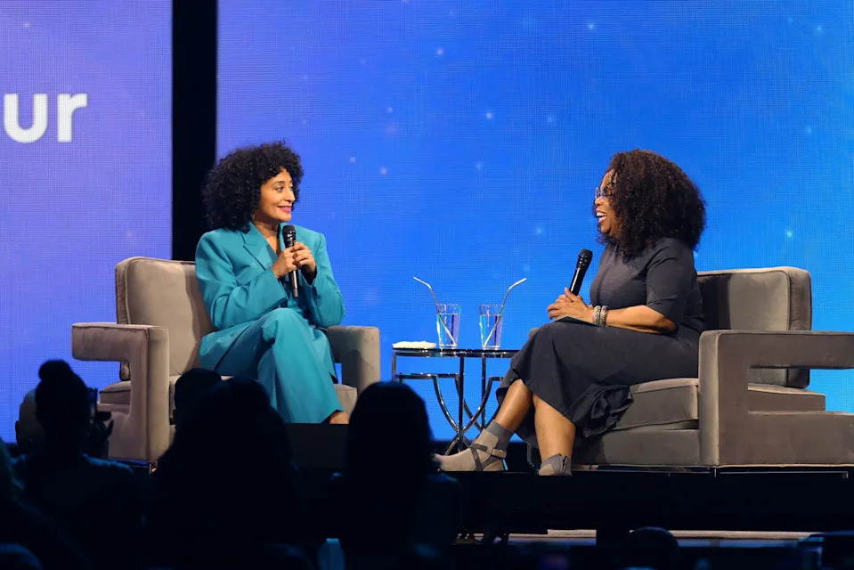 Tracee Ellis Ross and Oprah on stage in a discussion