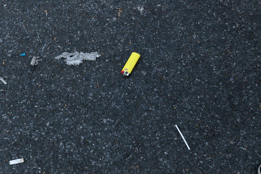 Yellow lighter on the ground.
