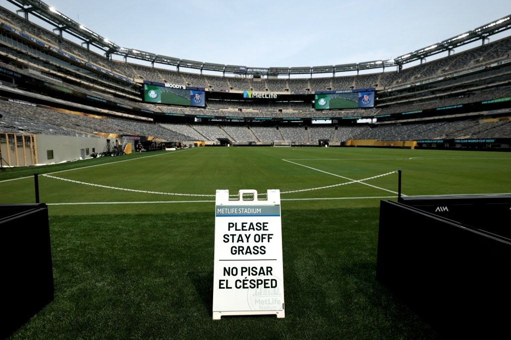MetLife Stadium field with "Please Stay Off Grass" sign.