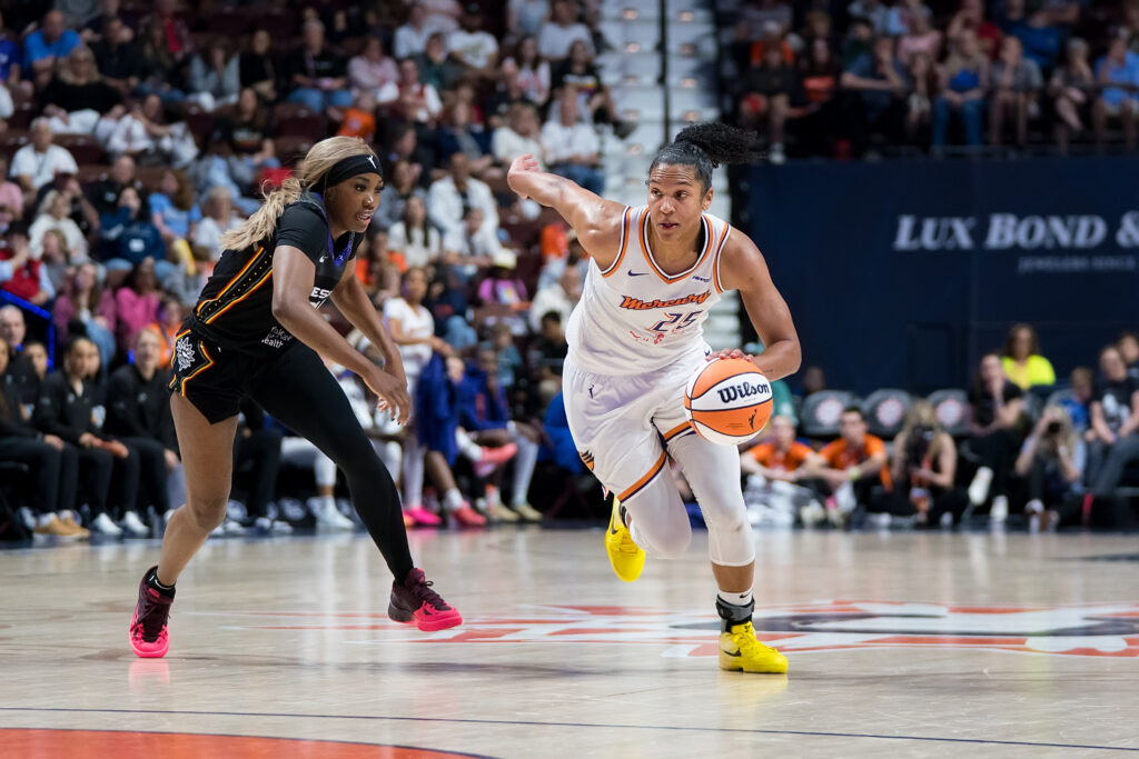 Phoenix Mercury forward Alyssa Thomas dribbles and runs while defended by Aneesah Morrow