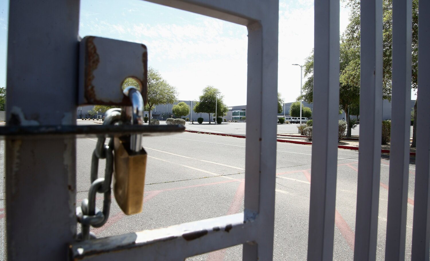 One of the many gates to Betty Fairfax High School is locked during a teachers strike May 1, 2018, in Laveen. A student walking across the street near Fairfax High was seriously injured in 2021, and the state Supreme Court ruled Tuesday the school is not responsible in the care of the students prior to arriving on campus. (Associated Press/Ross D. Franklin)