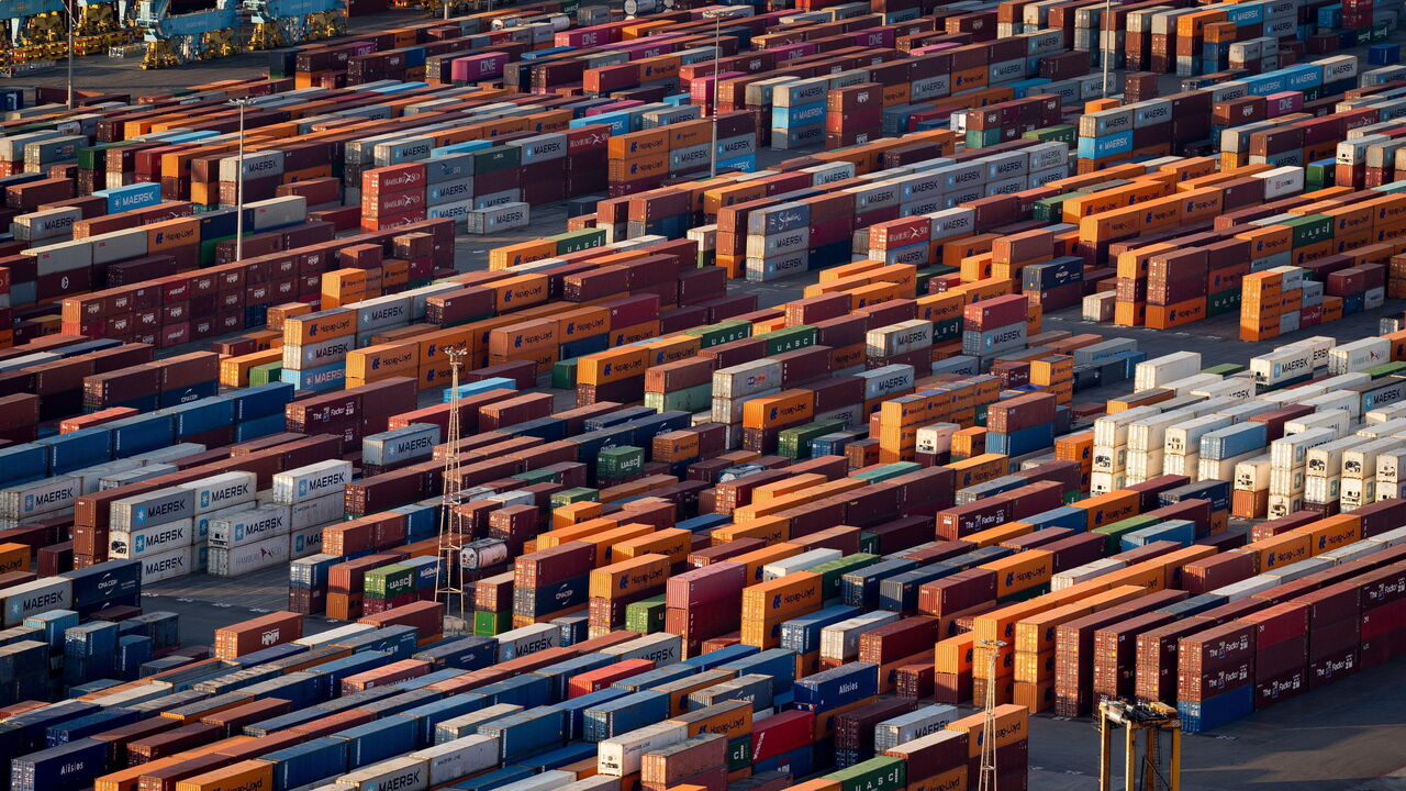 Shipping containers and cargo ships are seen in the port of Barcelona, Spain.