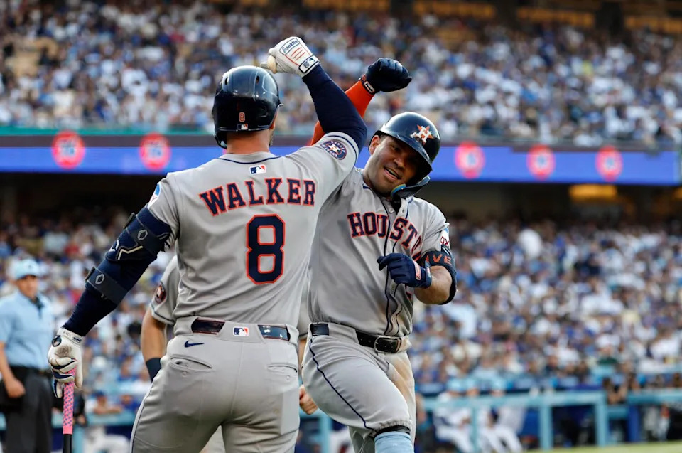 The Houston Astros' Jose Altuve celebrates with Christian Walker after hitting a two-run homer against Dodgers.