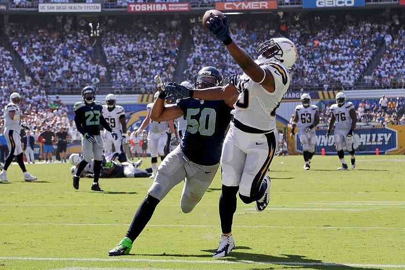 FILE - San Diego Chargers tight end Antonio Gates hauls in a touchdown catch as Seattle Seahawks outside linebacker K.J. Wright defends during the second half of an NFL football game, Sunday, Sept. 14, 2014, in San Diego. (AP Photo/Gregory Bull, File)