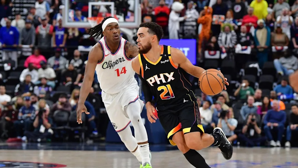 Oct 31, 2024; Inglewood, California, USA; Phoenix Suns guard Tyus Jones (21) moves the ball against Los Angeles Clippers guard Terance Mann (14) during the first half at Intuit Dome. Mandatory Credit: Gary A. Vasquez-Imagn Images© Gary A&period; Vasquez-Imagn Images