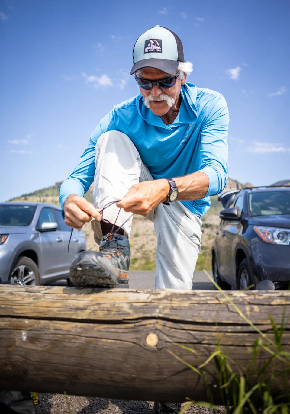  Doug Smith, who headed up the wolf project at Yellowstone National Park for nearly 30 years ties his shoelaces before setting out on the trail to scout for wolves on July 10, 2024, at Yellowstone National Park. (Photo by Pat Sutphin/For the Idaho Capital Sun)