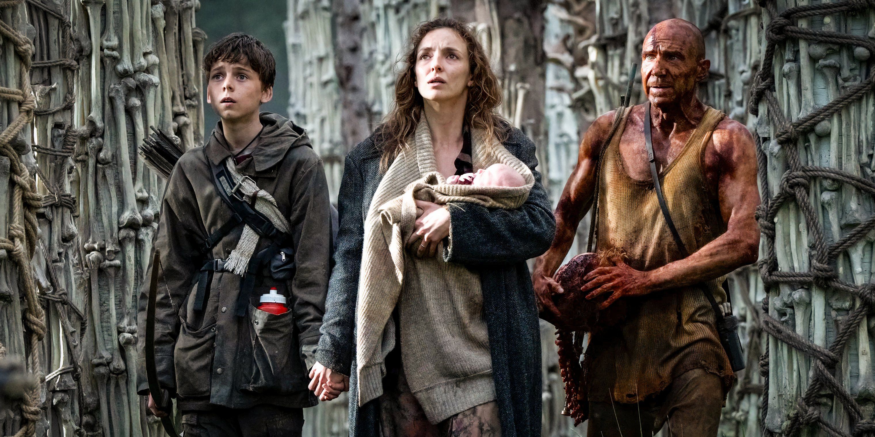 Alfie Williams, Jodie Comer, and Ralph Fiennes walking through a forest of bone-trees in 28 Years Later