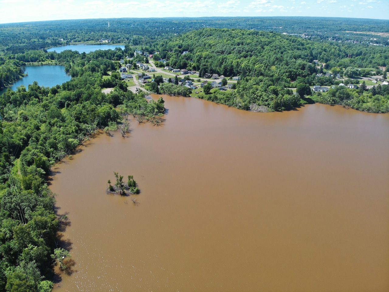 Crystal clear fishing lake turns red after beaver dam breach