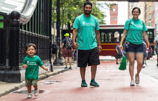 Alonzo Herazo, 1, (left) runs North on South Dearborn Street...