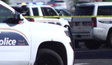 Standoff underway with armed suspect in busy west Phoenix parking lot