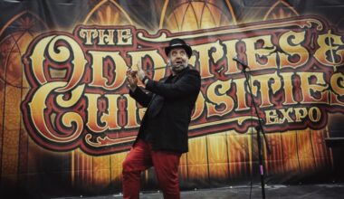 A performer onstage conducts sword swallowing.