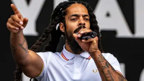 PA Media Bob Vylan performing on the West Holts Stage, during the Glastonbury Festival at Worthy Farm in Somerset. Glastonbury Festival has said it is "appalled" by the statements made by Bobby Vylan, of punk duo Bob Vylan, during their set on Saturday