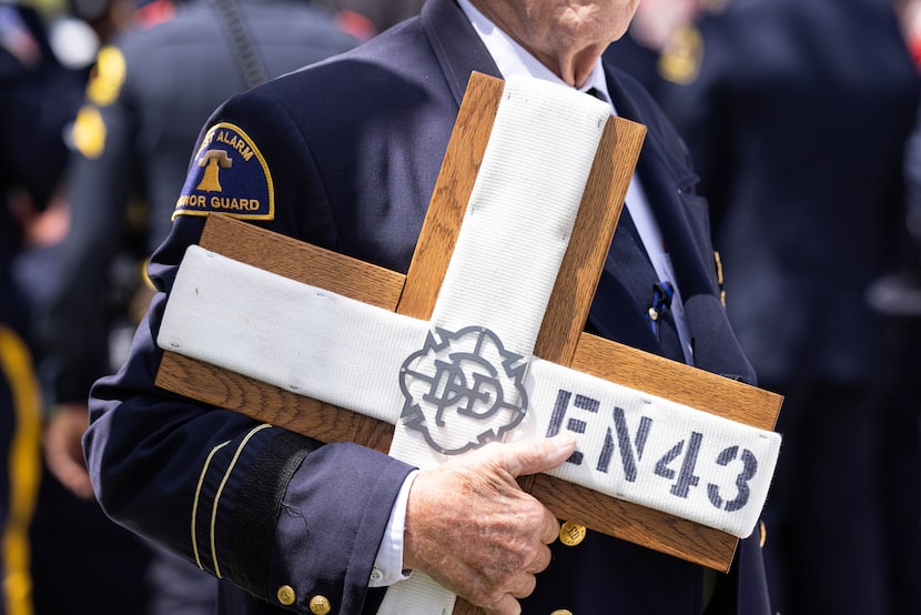 A cross bearing the insignia of Dallas Fire-Rescue Engine 43 honors firefighter Juan Omar...