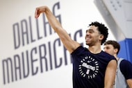 Dallas Mavericks rookie guard Ryan Nembhard follows through on a three-point shot following...