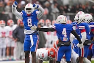 Duncanville defensive lineman Landon Barnes (8) celebrates after bringing down Cypress...