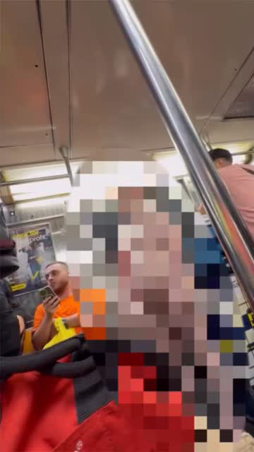 A blurred image of a man exposing himself on a subway train.
