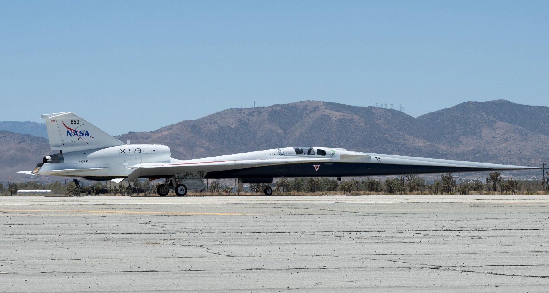 a long, slender aircraft drives across a runway