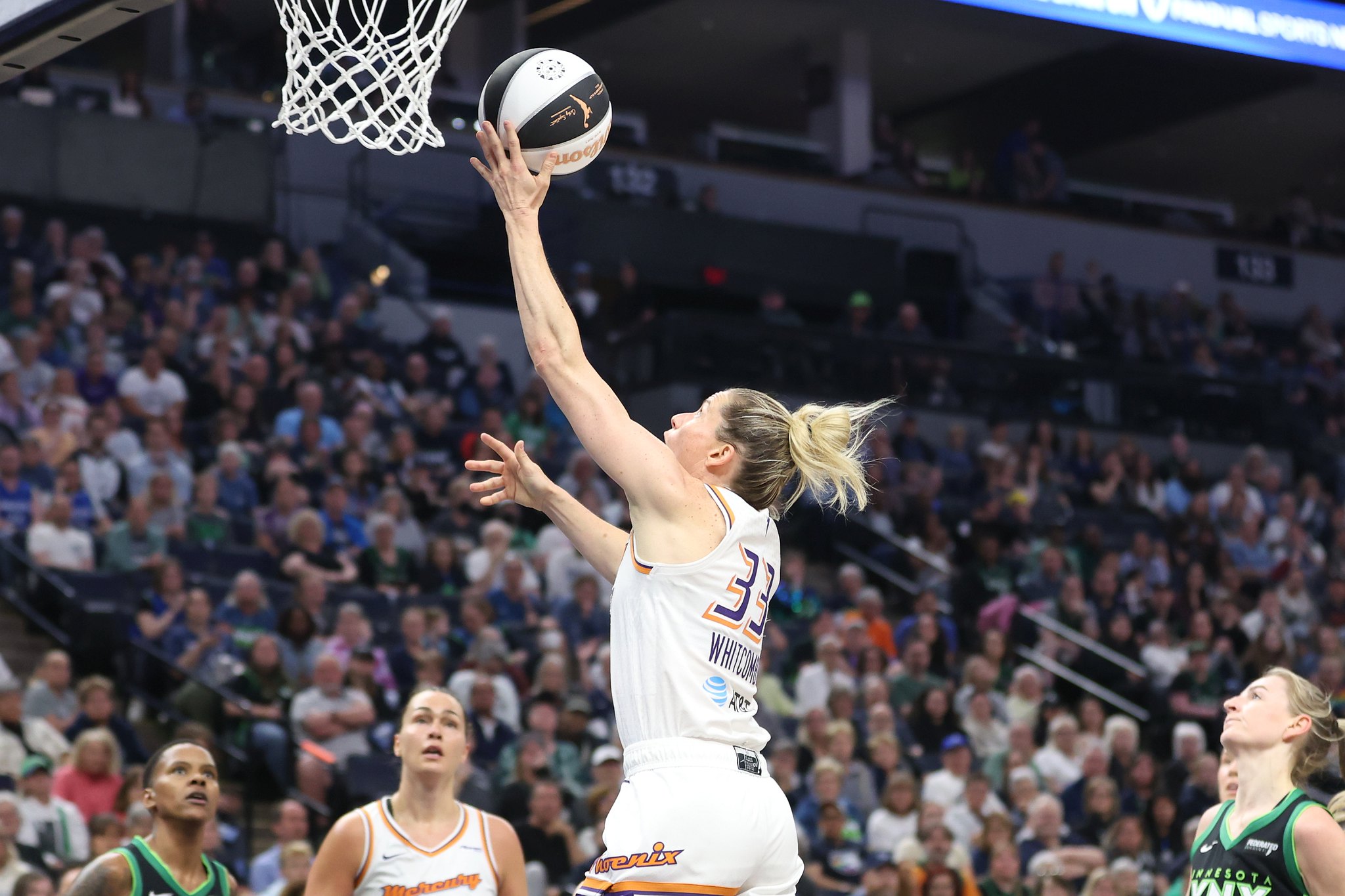 Phoenix Mercury guard Sami Whitcomb shoots right-handed layup while Kathryn Westbeld and Courtney Williams watch