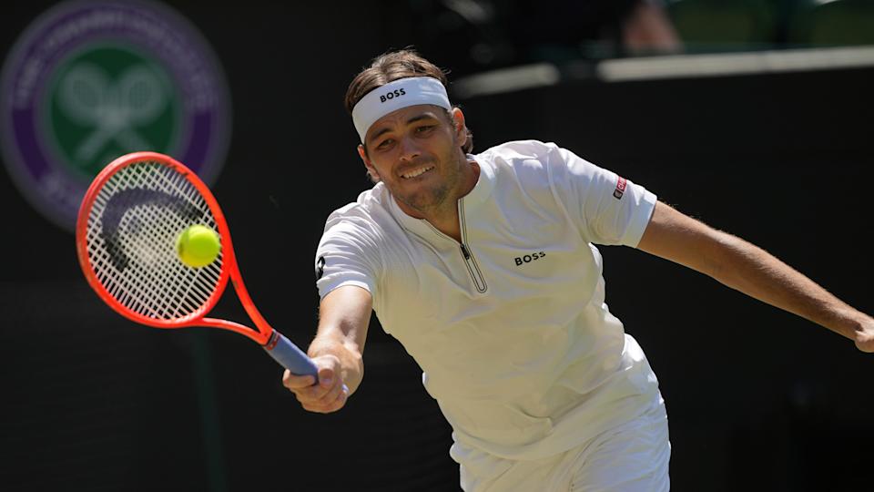 Taylor Fritz of the U.S. plays a return to Karen Khachanov of Russia during the men's singles quarter final match at the Wimbledon Tennis Championships in London, Tuesday, July 8, 2025.(AP Photo/Kin Cheung)