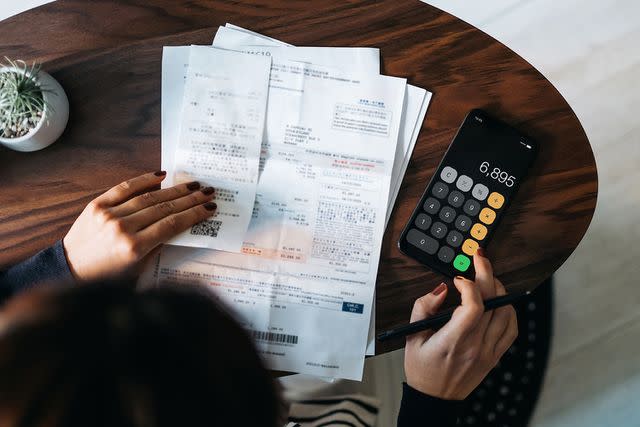 Getty Stock image of a person figuring out finances.