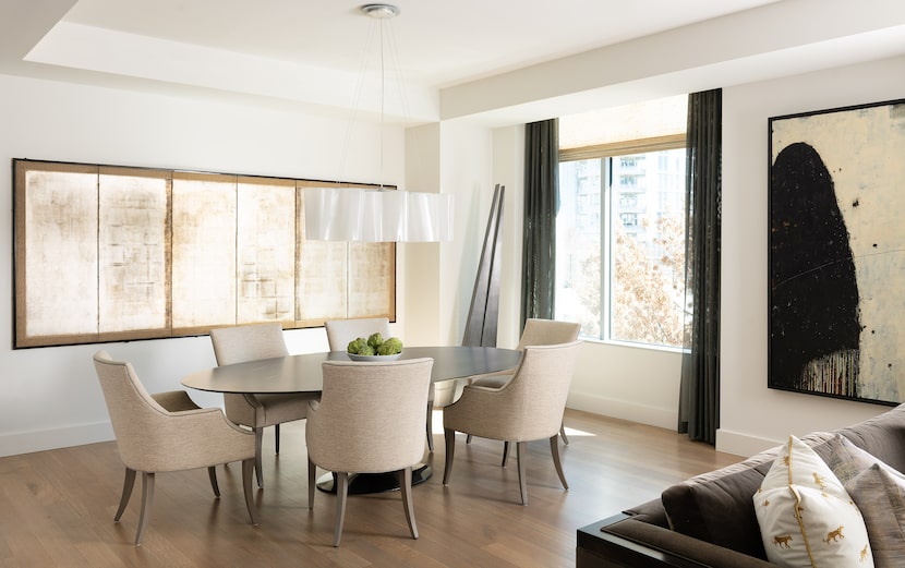 The condo features an open-concept formal living and dining space. The room is designed with...