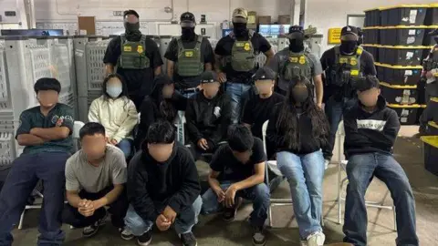 CBP 10 teenagers with their faces blurred to protect their identities sit in front of 5 federal immigration agents who also have their faces blurred. 