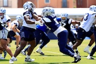 Dallas Cowboys defensive end Sam Williams (54) pass rushes tackle Hakeem Adeniji (75) before...