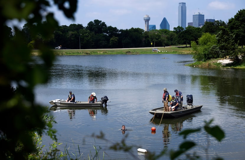 Members of the Dallas Police Department’s Underwater Recovery Team identify a pair of...