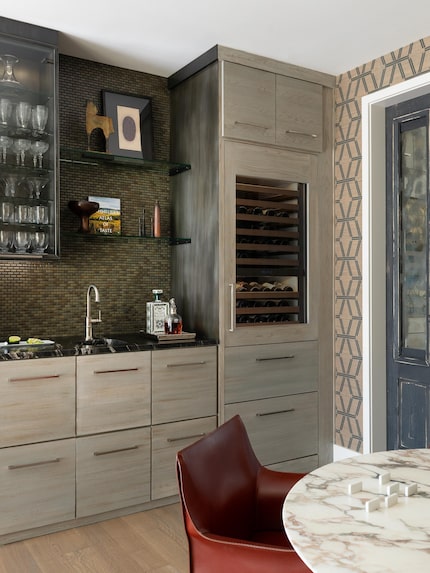 Designer Nicole Arnold sourced the vintage-style doors in the den. "The white doors that...