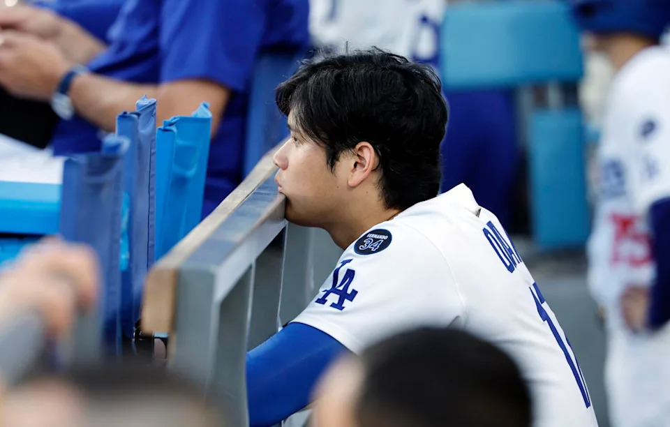 Dodgers star Shohei Ohtani looks subdued while watching from the dugout as his team loses 18-1 to the Houston Astros.
