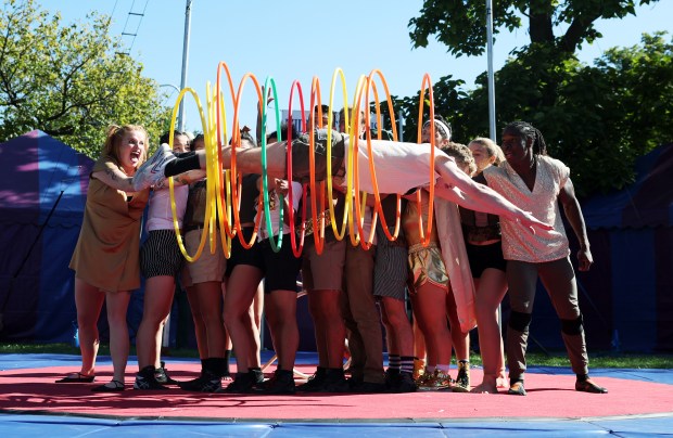 Midnight Circus member Nate Armour dives through several Hula Hoops...