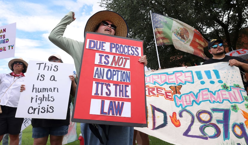 Magdalena Morales, a registered nurse in Dallas, pumps her fist as she voices her support...