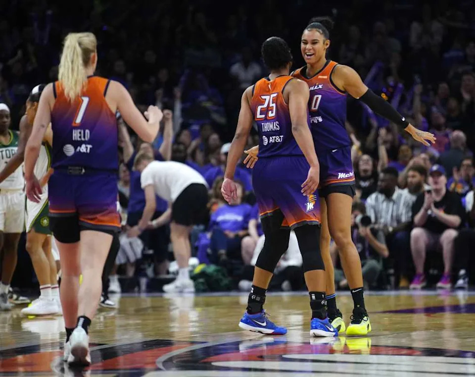 Phoenix Mercury forwards Satou Sabally and Alyssa Thomas and guard Lexi Held celebrate after forcing a Seattle Storm timeout during the Mercury home opener in the PHX Arena in Phoenix on May 17, 2025.© Patrick Breen&sol;The Republic &sol; USA TODAY NETWORK via Imagn Images