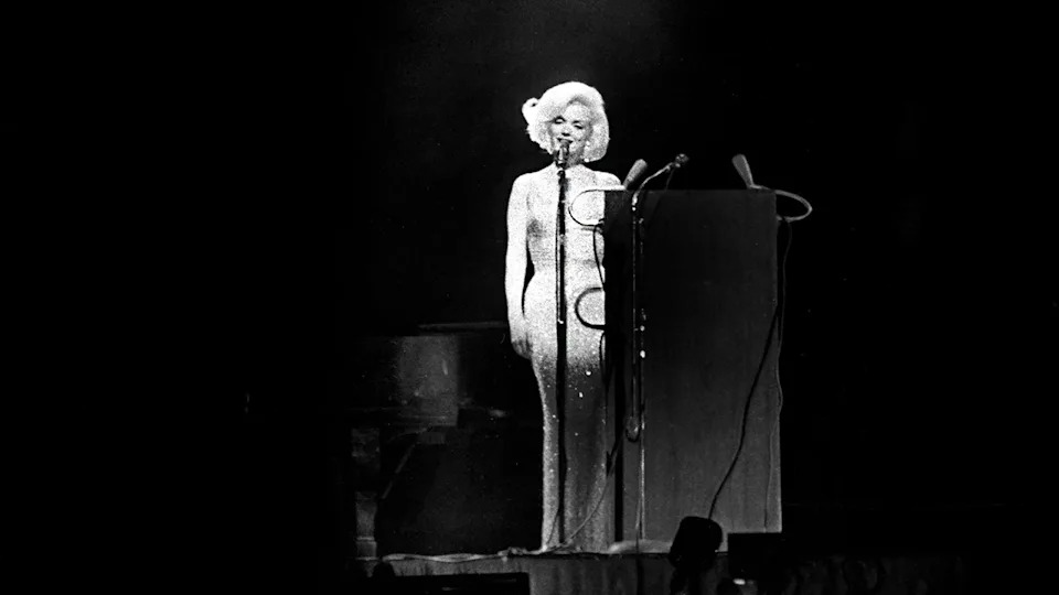 Marilyn Monroe on stage singing.