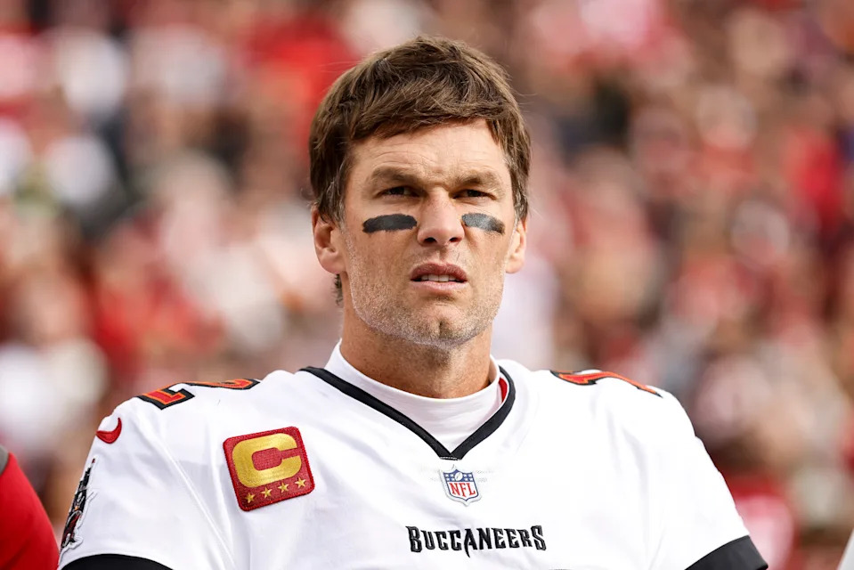 A football player wearing a uniform with captain insignia, looking focused during a game