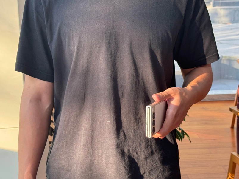 A rumored real life photo of a person holding TECNO's Ultimate G Fold in its folded state.