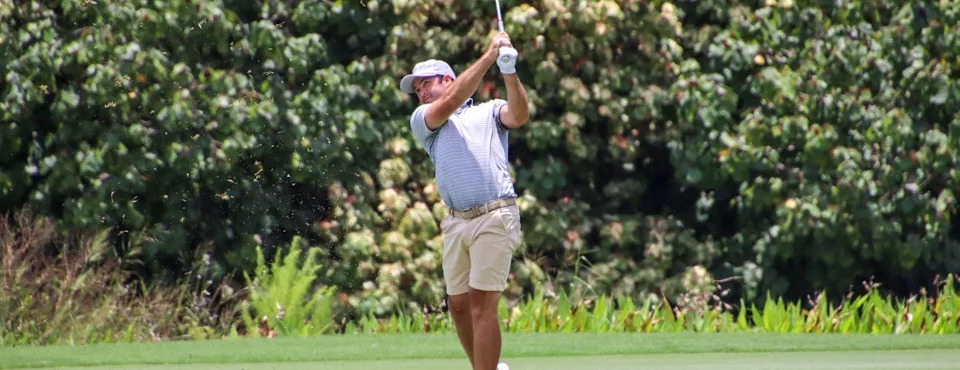 Allin Crouch of Jacksonville watches a shot go down the fairway at the Quail West Country Club in Naples on July 18 during the first round of the Florida Open. Crouch shot 64 to take a two-shot lead.