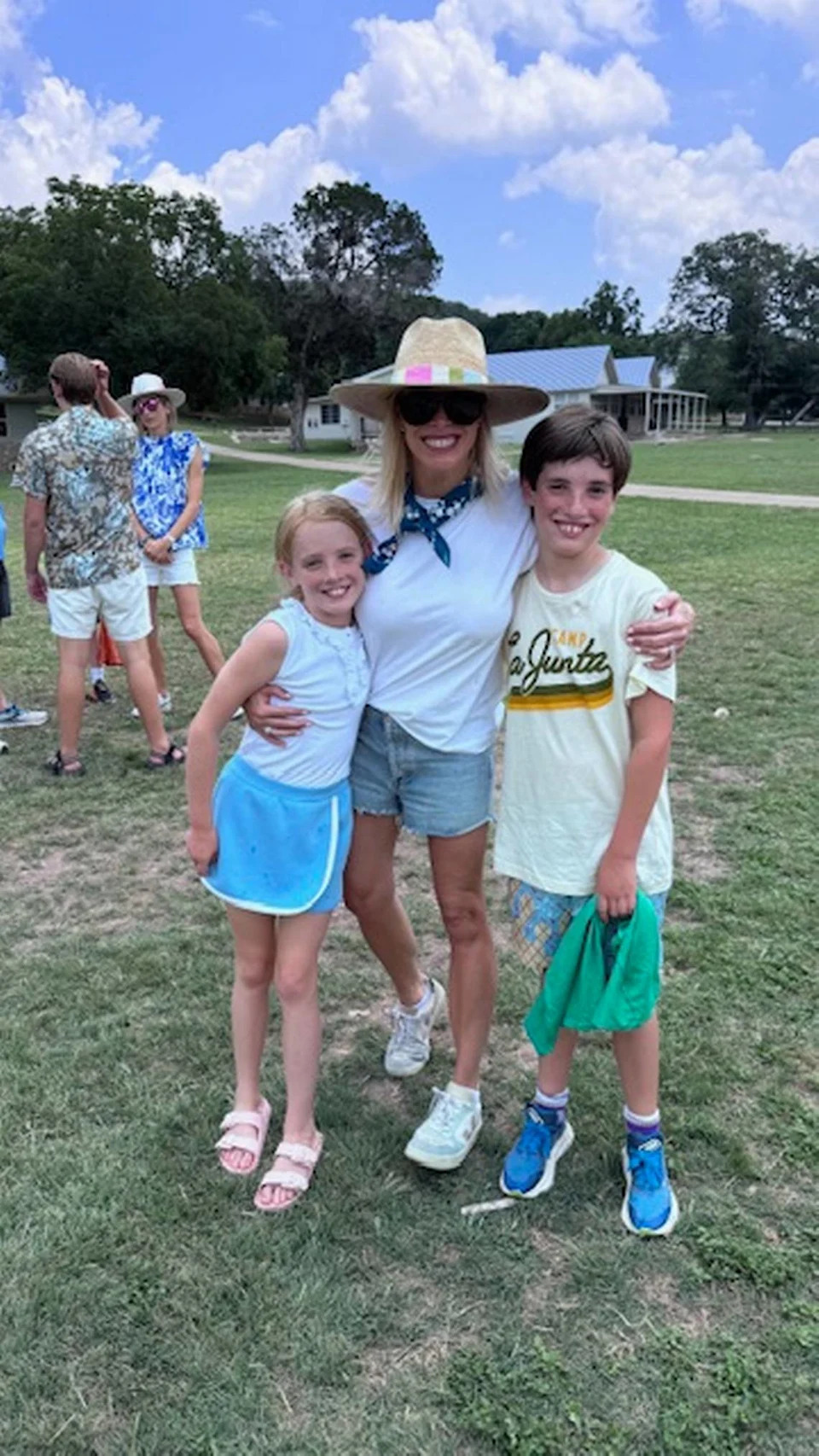 Corrigan and Cannon Camp, 9-year-old twins from Fort Worth, pose with Tweety Eastland, one of Camp Mystic’s co-owners and co-directors, in June 2025. Cannon attended the nearby Camp La Junta.