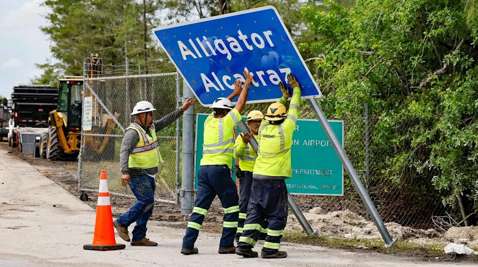 Workers install a permanent Alligator Alcatraz sign. The facility is within the Florida Everglades, 36 miles west of the central business district of Miami, in Collier County, Florida. , Florida, on Thursday, July 3, 2025.