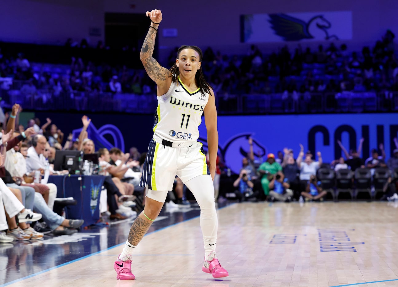 Dallas Wings guard JJ Quinerly (11) reacts after sinking a first quarter three-pointer...