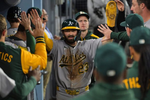 The Athletics' Shea Langeliers celebrates in the dugout after scoring on a Miguel Andujar double during the fourth inning of their game against the Dodgers on Wednesday, May 14, 2025, at Dodger Stadium. (AP Photo/Jayne Kamin-Oncea)