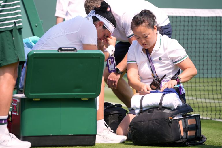 Ons Jabeur of Tunisia get medical assistance during her match against Varvara Gracheva of France at the first round singles match at the Wimbledon Tennis Championships