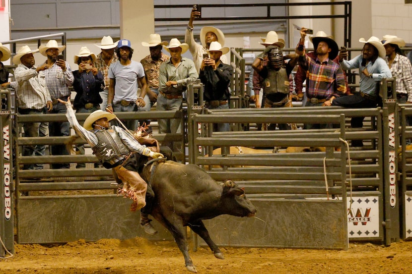Kaleb Lewis of Kaufman, Texas, competes in bull riding during Texas Black Invitational Rodeo...