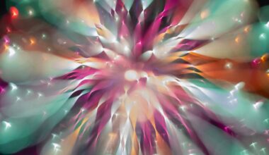 A vibrant, abstract burst of colors including teal, pink, orange, and white, radiating outward from a central bright point, resembling an explosion or a firework viewed through a soft, dreamy lens.