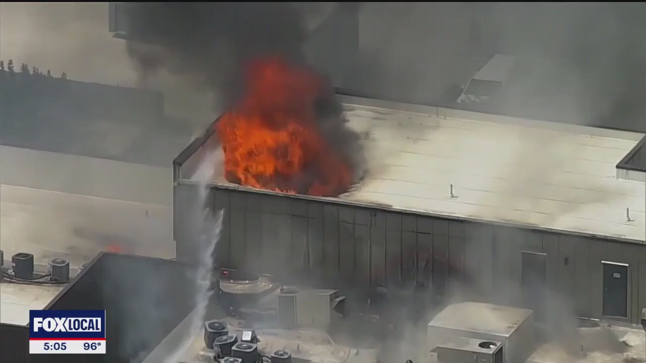 Residents try to collect belongings after building fire