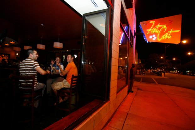 Andre Arguijo, left, Kelly Beeman, center, and Ben Lamers spend an evening at Fat Cat in 2007. (Jasmin Shah/for the Chicago Tribune)