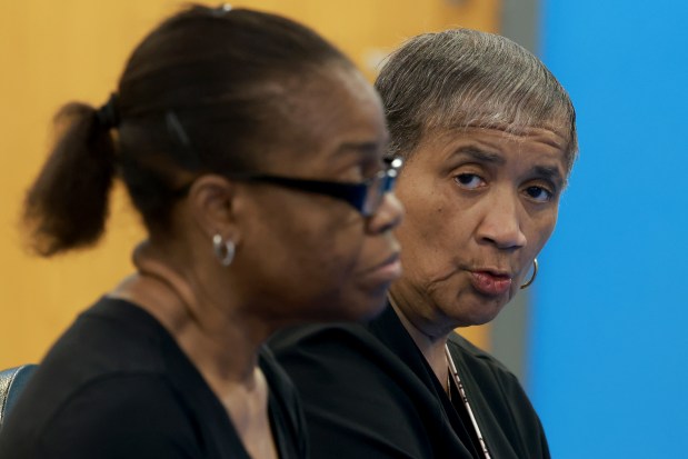 Vernell Givens, right, answers questions from the media during a CHA Central Advisory Council board meeting at a CHA complex on July 22, 2025. At left is Charnie Harmon. (Antonio Perez/Chicago Tribune)