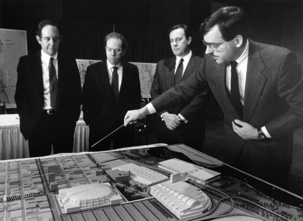 Kim Goluska, right, of Skidmore, Owings and Merrill, goes over a model of a new McCormick Place with the Metropolitan Pier and Exposition Authority's John Schmidt, from left, Jim Reilly and Pat Daly. (Charles Osgood/Chicago Tribune)