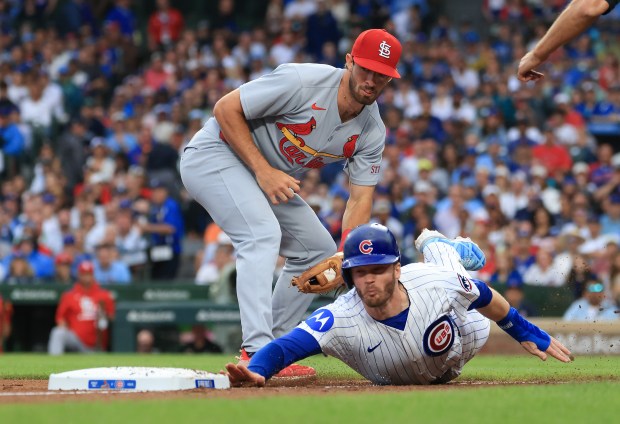 Cubs left fielder Ian Happ gets caught in a rundown by Cardinals third baseman Thomas Saggese in the the second inning at Wrigley Field on July 6, 2025, in Chicago. (John J. Kim/Chicago Tribune)