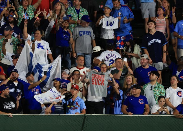 A Cubs fan holds up a T-shirt that reads, "CARDINALS SUCK," as he and fellow fans celebrate an 11-0 Cubs win over the Cardinals at Wrigley Field on July 6, 2025, in Chicago. (John J. Kim/Chicago Tribune)